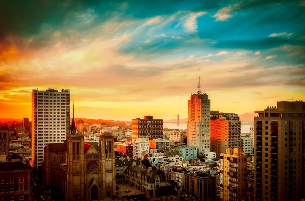 buildings-under-cloudy-sky-during-sunset-462331 Stunning view of San Francisco cityscape with Golden Gate Bridge at sunset, vibrant urban atmosphere.